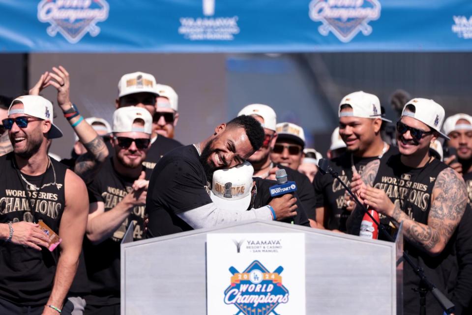 Dodger Teoscar Hernandez hugs teammate Mookie Betts during the team's World Series celebration Nov. 1.