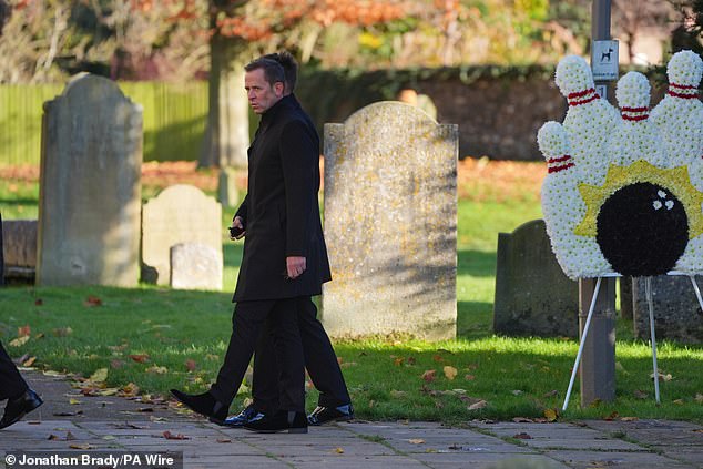 Scott Mills, who was yesterday revealed as the new presenter of the Radio 2 Breakfast Show, walks past a flower display showing skittles and a ball. This is a nod to Payne's love of bowling, which Cassidy said he practiced four times a week.