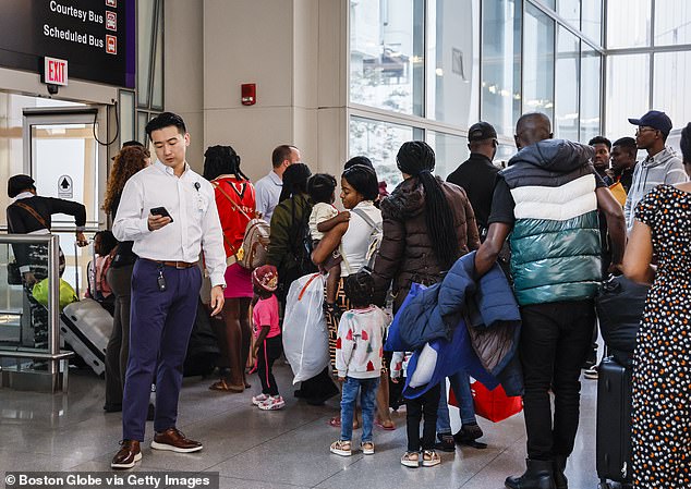 The Trust Act allows some city agencies, such as police, to opt out of cooperating with ICE for arrests on civil warrants (Photo: Migrants at Boston's Logan Airport)