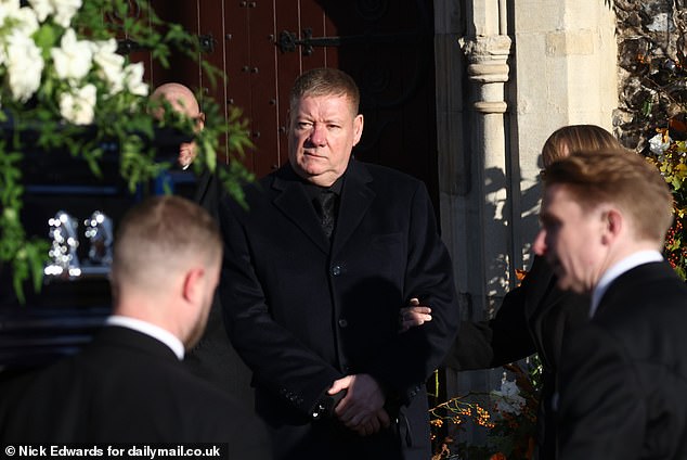 Liam Payne's father Geoff stands outside the church ahead of his son's funeral today.