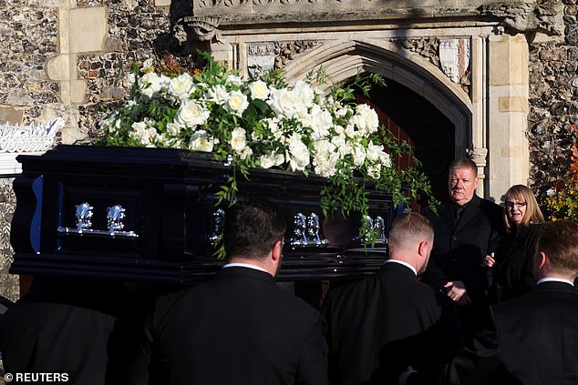 Liam Payne's coffin is carried into the church as his father Geoff and mother Karen look on.