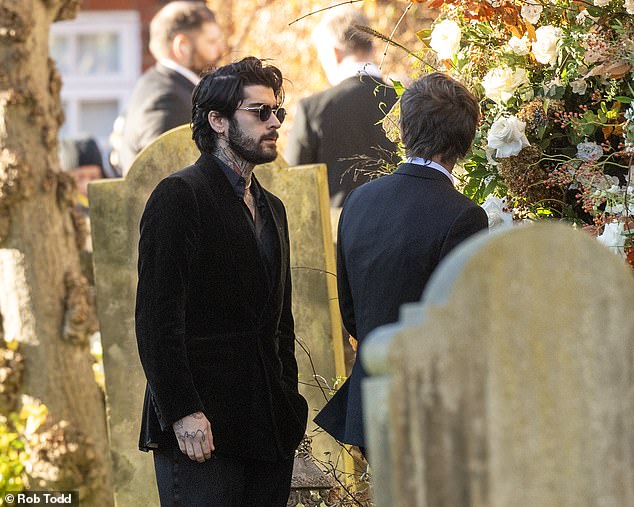 His bandmate Zayn Malik pictured at the funeral today.