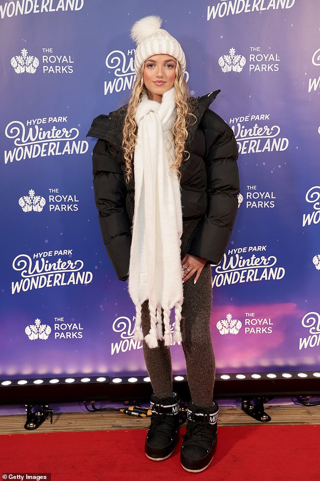 Princess warm in a white pompom hat, matching scarf and quilted coat