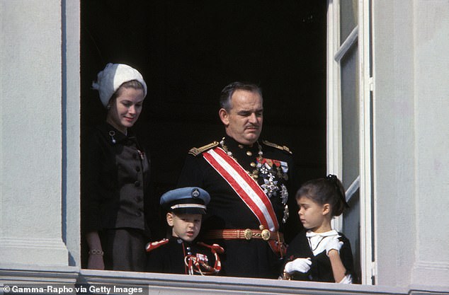 Grace Kelly photographed on a balcony in 190 wearing a chocolate brown skirt suit