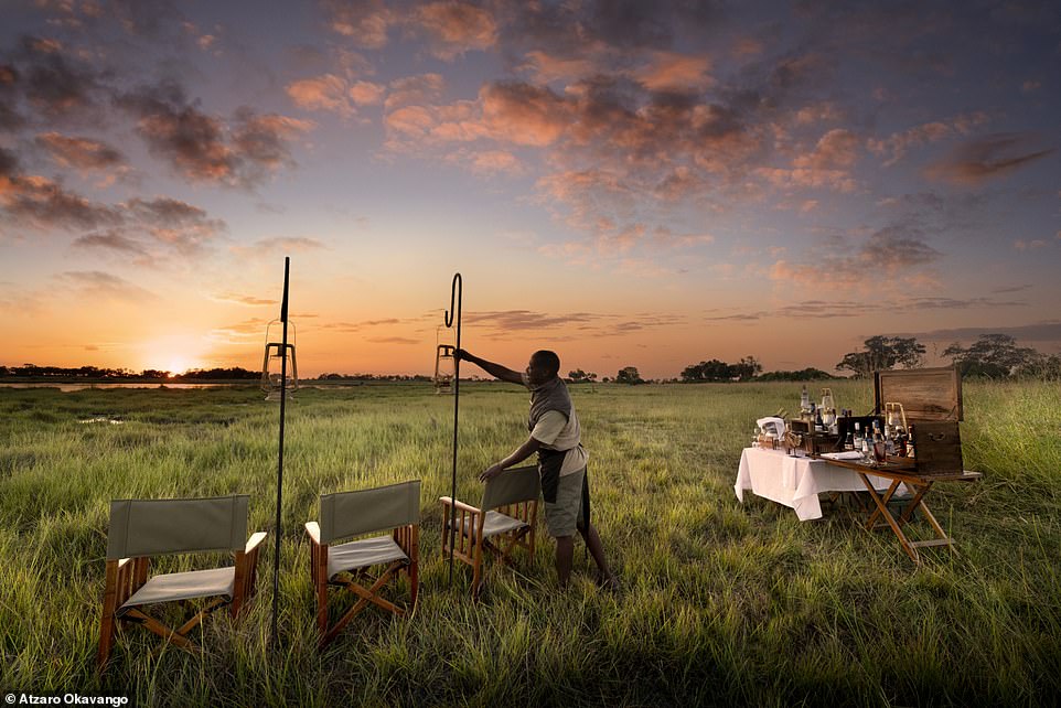 Jess drinks a gin and tonic before a 'striking red sunset and a lagoon where lots of hippos swim'