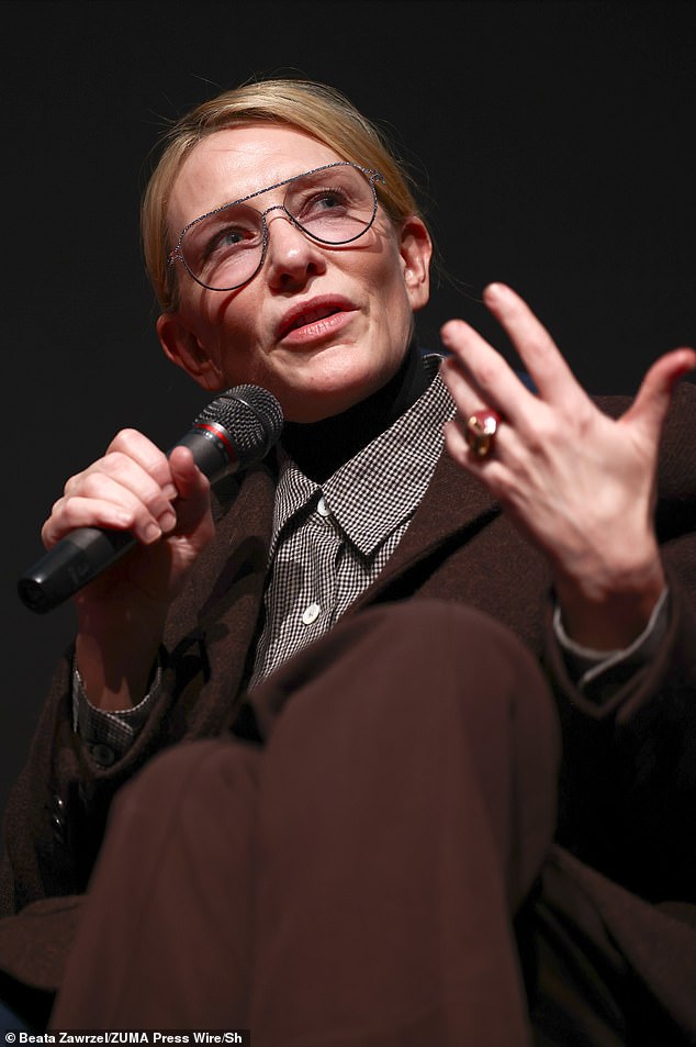 The actress donned sleek brown pants and a textured brown jacket over a plaid button-down shirt as she took the stage at the event.