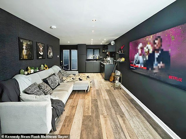 Black walls and fixtures adorn the open-plan living room downstairs, but the upstairs remains bright and less unorthodox