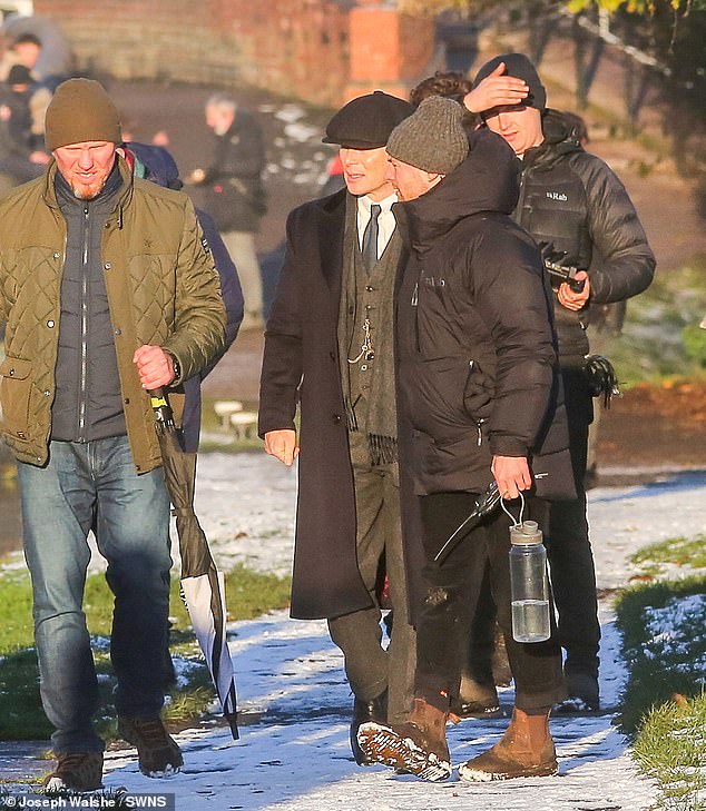 He was surrounded by crew members as he walked along the canal between takes on Wednesday.