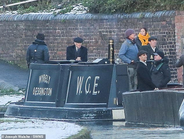 The Irish actor wore Shelby's signature coat and a Baker Boy cap as cameras rolled during a photo shoot at Dudley Canal at Bumble Hole and Warrens Hall Nature Reserve.