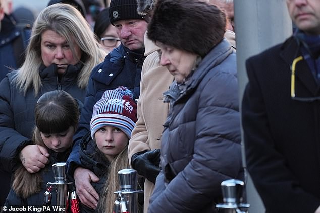 Pictured: A minute of silence is observed during a memorial service at 1000 Trades Square today.