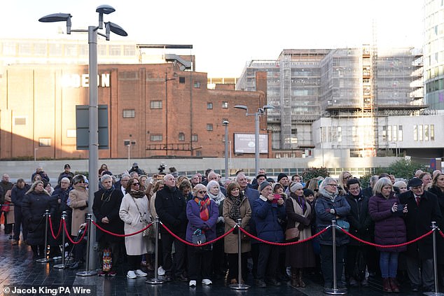 Members of the public during a memorial service at 1000 Trades Square, outside New Street station in Birmingham