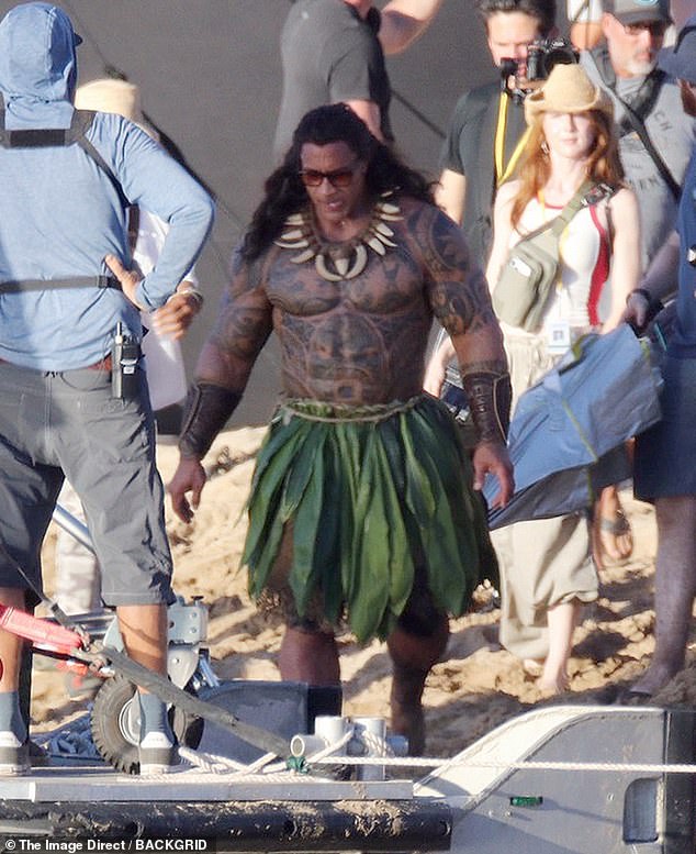 The You're Welcome singer, known for his signature bald head, sported a raven wig and whale necklace, topped off with sunglasses between takes as he strolled around the set as the character Maui.