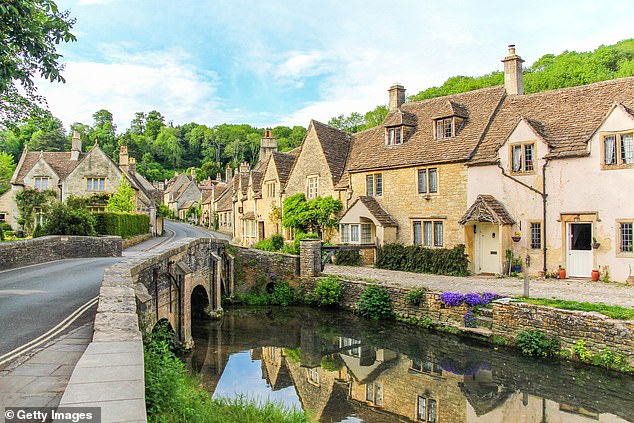 The TV presenter, 66, and her wife Portia de Rossi, 51, have moved to the Cotswolds, according to a new report from The Wrap; Cottages pictured at Castle Combe in the Cotswolds, England