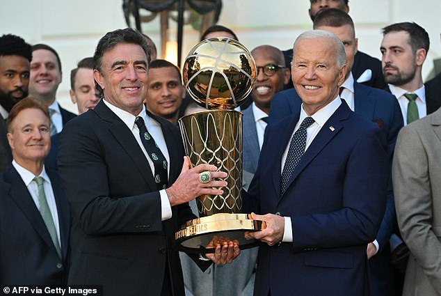 Biden poses with Boston Celtics Governor Wyc Grousbeck and the Larry O'Brien Trophy