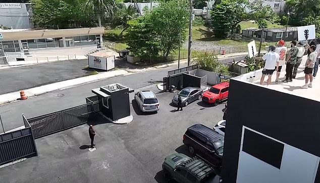 The group took to the roof to protest as Shea and his crew drove away from the site