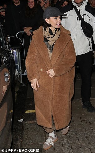 Lily bundled up in an oversized teddy bear coat and a scarf which she layered over a brown tracksuit.