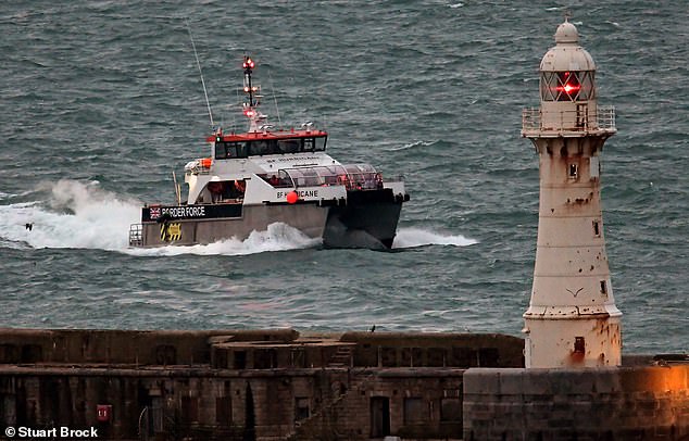 British Border Force officers escort migrants to Dover docks in Kent, UK