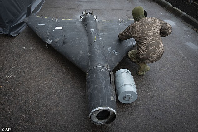 A Ukrainian officer examines a downed Shahed drone with thermobaric payload launched by Russia in a research laboratory at a secret location in Ukraine