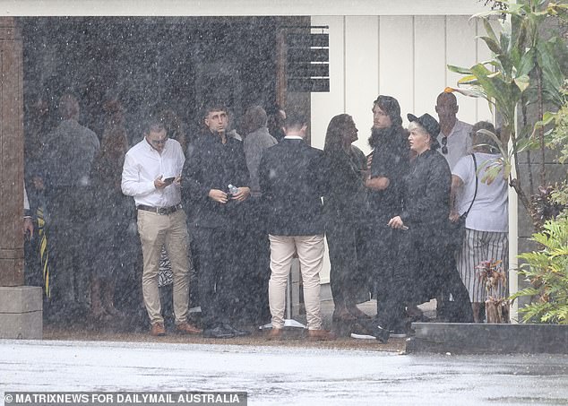 Rain lashed the event as mourners paid tribute to the bodybuilder.