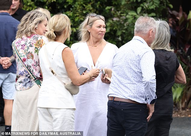 Mourners are seen at Friday's funeral.