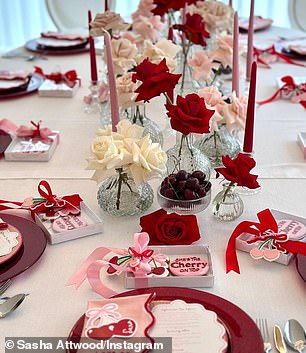 The new mother invited her close friends to a luxurious afternoon tea with the table decorated with red plates, roses, pink candles and cherries.