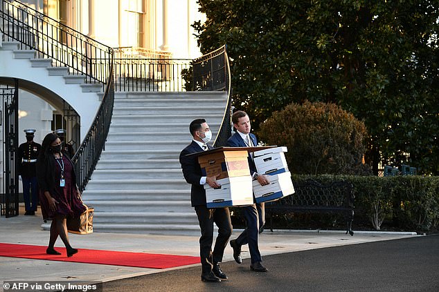 William Beau Harrison (right) carries boxes from the Trump White House on January 20, 2021 – the last day Donald Trump was president