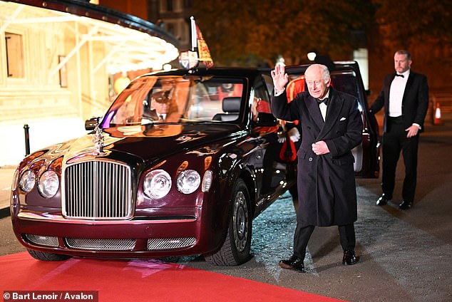 The king exited the royal Rolls Royce as he waved to the crowd at the entrance of the hall