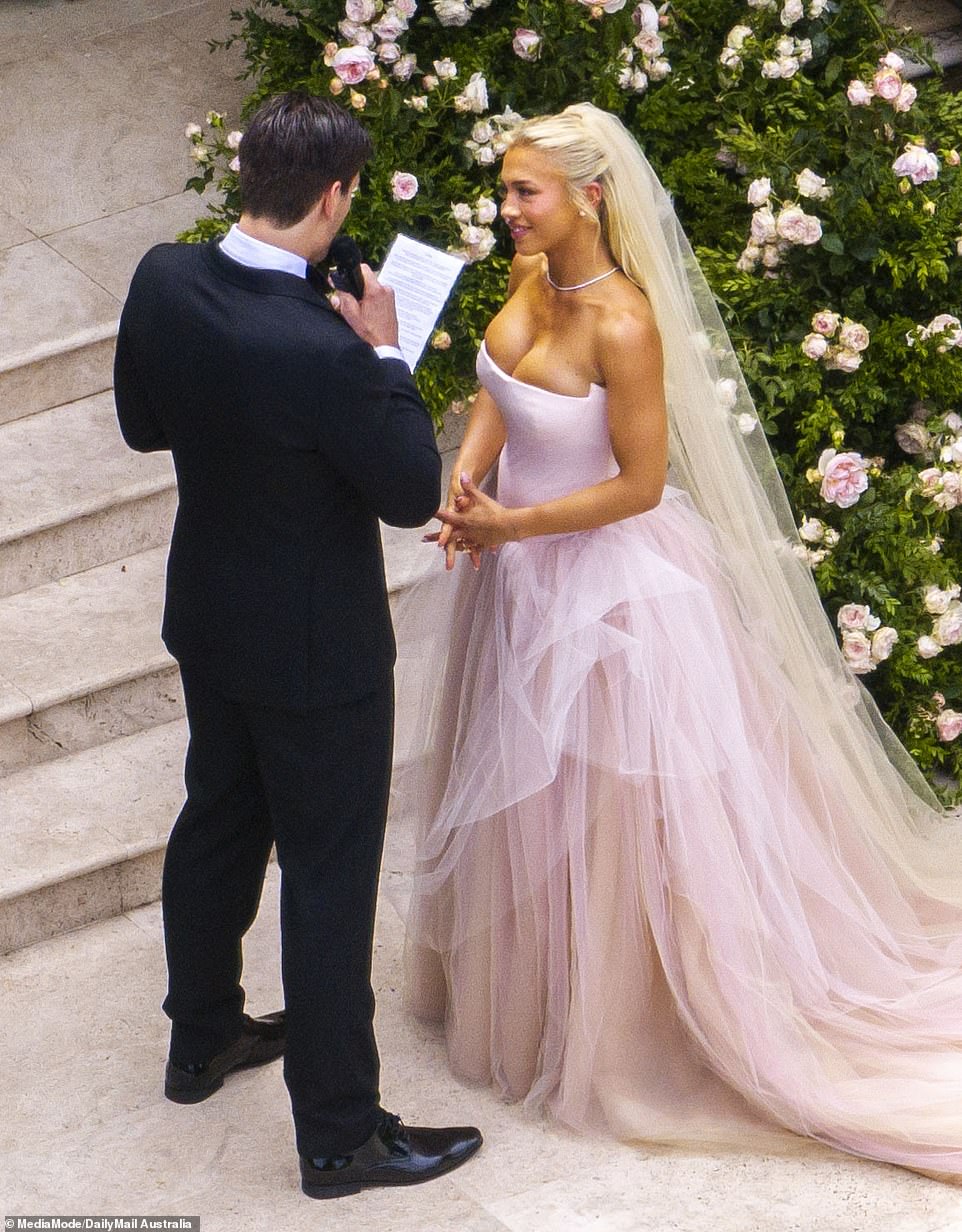 The fitness entrepreneur looked into her husband's eyes as he read her long vows.