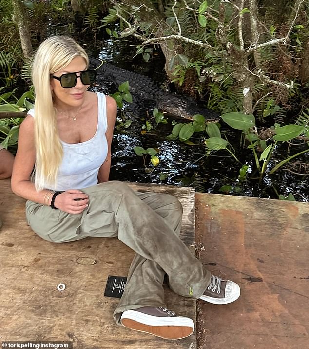 In one shocking snapshot, he got up close and personal with an alligator on the Florida set, smiling fearlessly alongside the dangerous reptile that is almost difficult to spot in the swamp.