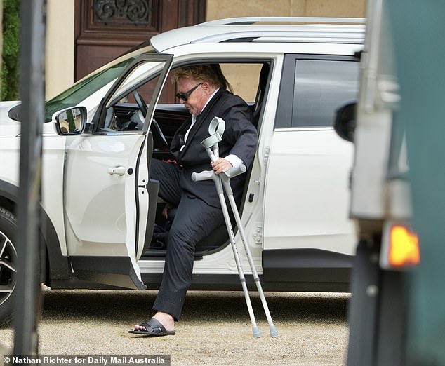 The veteran actor, 69, was seen with a pained expression as he held crutches and tried to get out of his car outside the Chateau Du Soleil venue in Byron Bay.