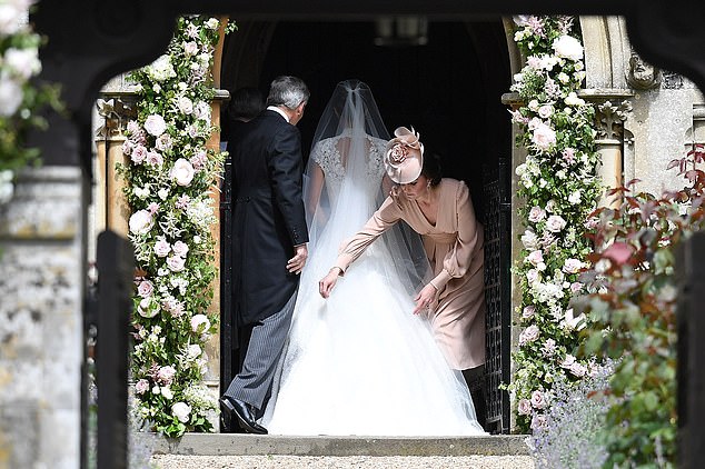 Kate adjusting her sister's dress as she entered the church on her wedding day