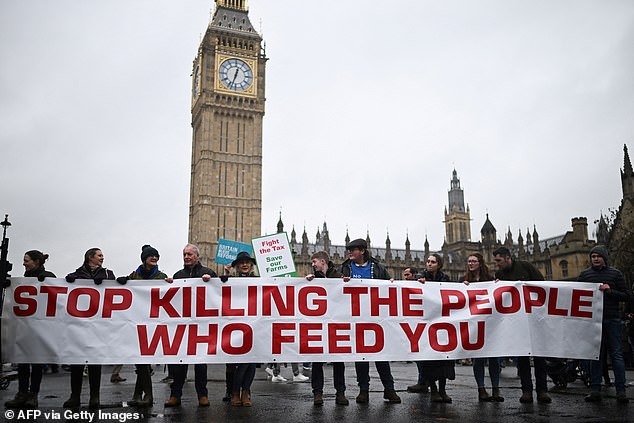 Speaking: farmers' banner at the protest outside Parliament