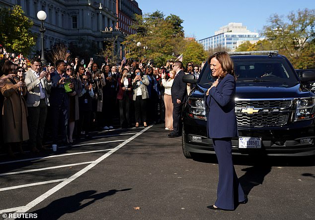 US Vice President Kamala Harris reacts as administration staff applaud her outside the White House in Washington.