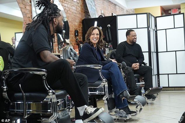 Democratic vice presidential candidate Kamala Harris, center, chats with black men at the Philly Cuts barbershop on Oct. 27, 2024, in Philadelphia.