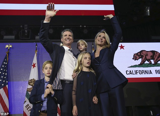 Gavin Newsom and his family wave to the crowd at an election night party in Los Angeles after being elected in 2018. All four of his children are now of high school age.