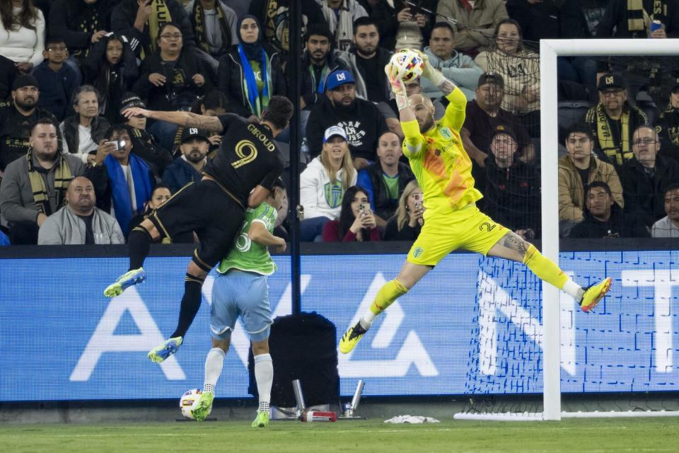 Seattle Sounders goalkeeper Stefan Frei, right, catches the pass intended for LAFC forward Olivier Giroud.