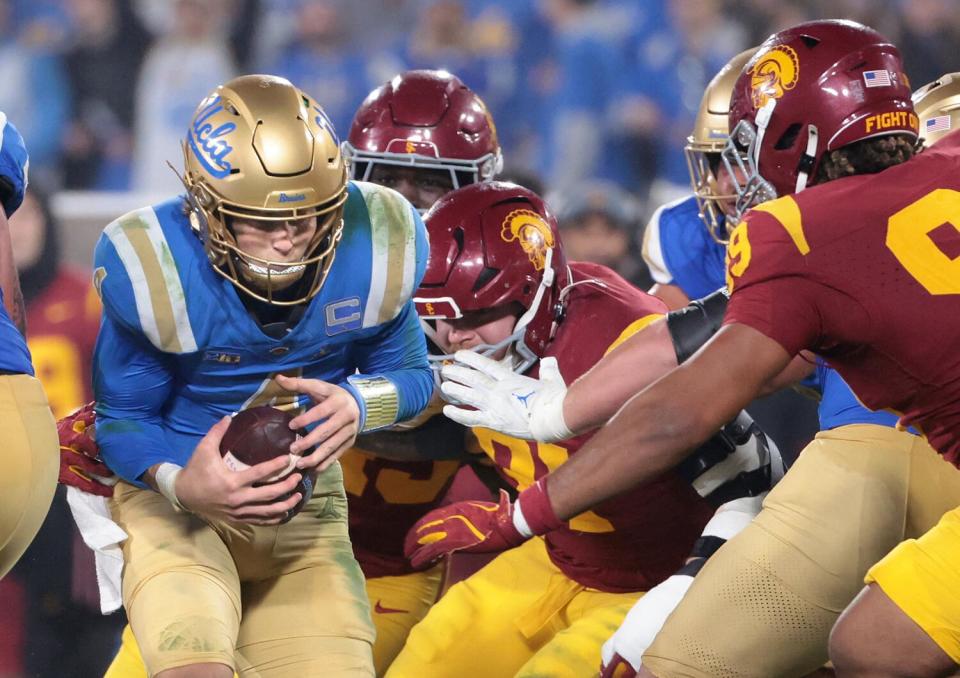 UCLA quarterback Ethan Garbers is sacked by the USC defense in the third quarter on Saturday.