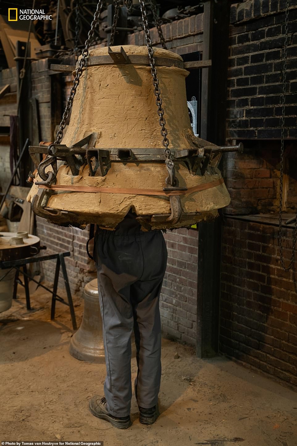 A craftsman inspects a special mold, created at Cloches Cornille Havard, a foundry in Normandy, to repair one of the damaged bells. Nat Geo adds: 'Notre Dame's two bell towers house 10 brass bells. The largest is called Emmanuel and hangs in the south tower, where it was undamaged during the fire. Cast in 1683 under Louis Eight smaller bells in the north tower had to be removed and cleaned of soot; two of them were damaged and had to be restored.