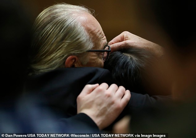 The stepfather of the González brothers, Kurt Schilling, comforts the mother of those killed by Farmer, Paulina González