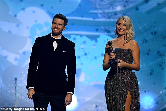 The annual show celebrates the best of television and has been presented by David Wallaims, Dermot O'Leary and Sir Trevor McDonald (pictured with Holly Willoughby at the 2024 ceremony).