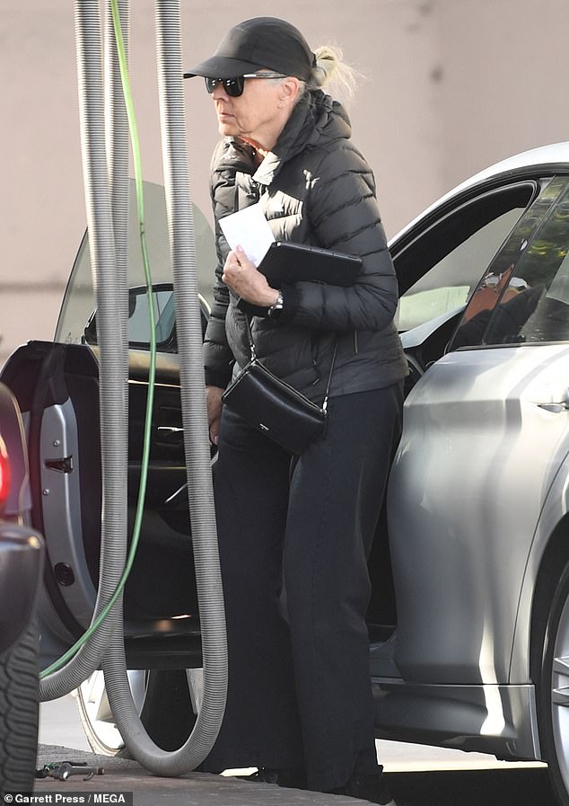 She appears to be embracing her natural gray hair and kept it low-key in an all-black sporty ensemble that featured a black puffer coat, pants, sneakers, and a small crossbody bag.