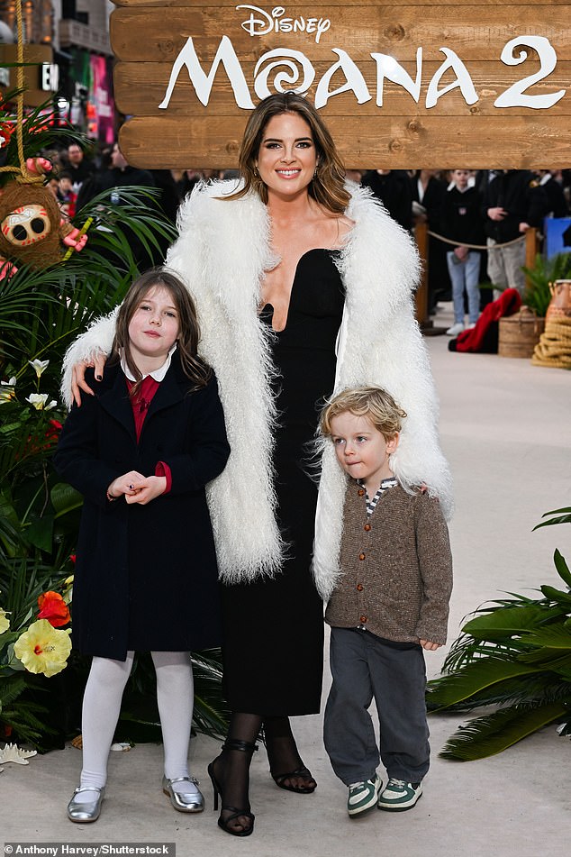 Made in Chelsea's Binky cut a glamorous figure in a black Bardot bodice dress as she arrived with her two eldest children, India, seven, and Wolfie, three.