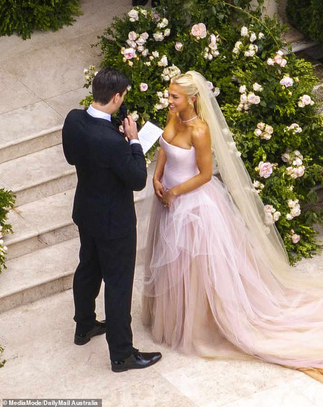 Regardless of what her intentions were, McEvoy's choice of clothing ensured that the narrative was not entirely exclusive to the bride. (Hembrow and Zukowski are shown exchanging vows)