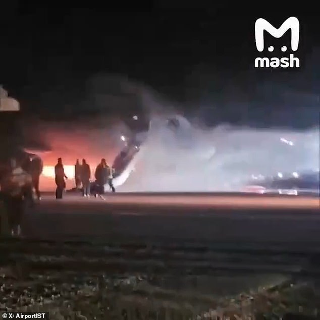 Huge plumes of smoke can be seen rising into the night sky and panicked voices can be heard as fire crews use multiple hoses to battle the blaze.