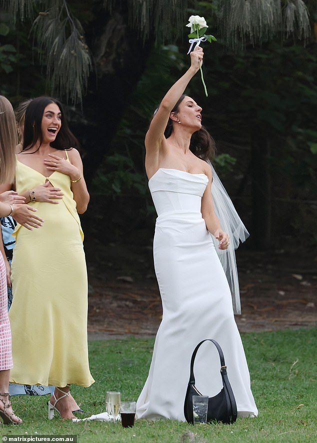 Emily looked stunning in a strapless white dress with a fitted bodice and elegant skirt.