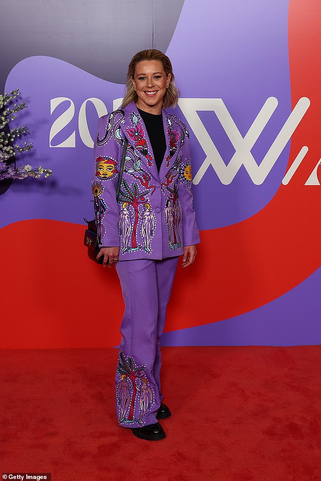 Brisbane Lions star Kate McCarthy stood out in a purple ensemble with a bright cartoon print throughout.