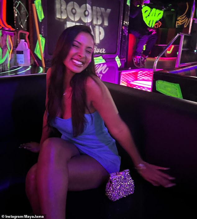 During another night out, the star dressed to impress in a strapless blue opaque mini dress as she smiled for a photo in a bar.