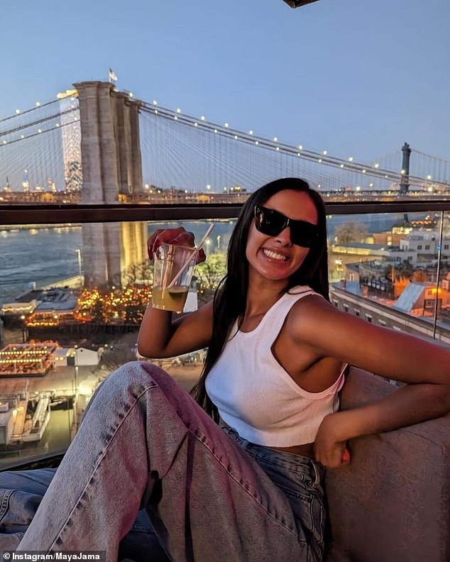 In another image, Maya cut a casual figure in a white crop top and gray wide-leg jeans as she enjoyed a night out sipping cocktails at a rooftop bar.