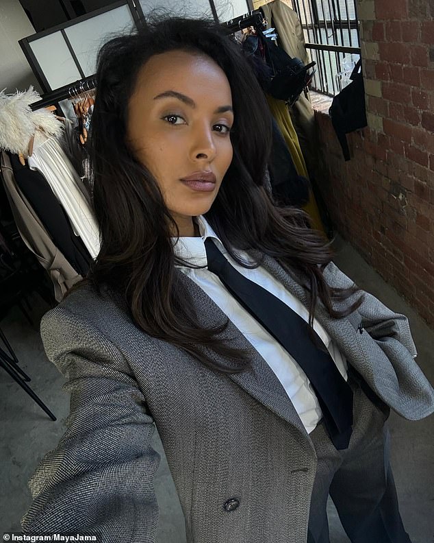 The beauty cut a modern figure in a tweed suit and black tie as she posed for a selfie.