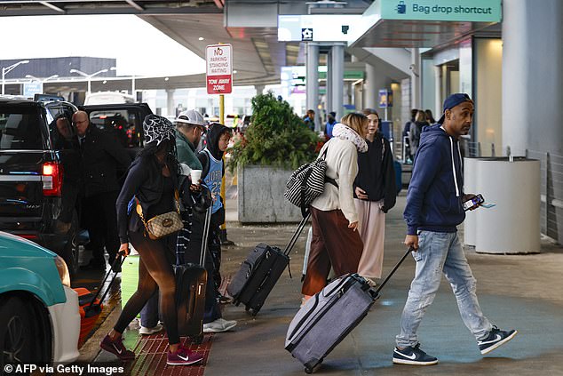 Travelers arrive at O'Hare International Airport in Chicago, Illinois on November 22, 2024, ahead of the upcoming Thanksgiving holiday